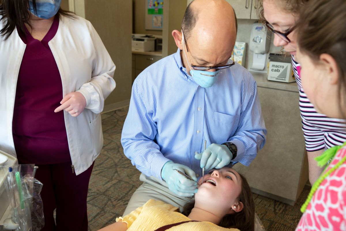 Dr. Cowan working on a patient's teeth